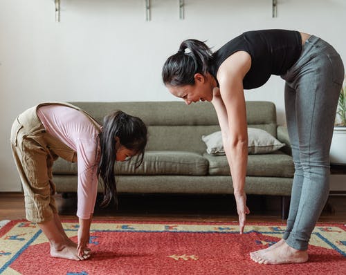 Woman and child doing yoga